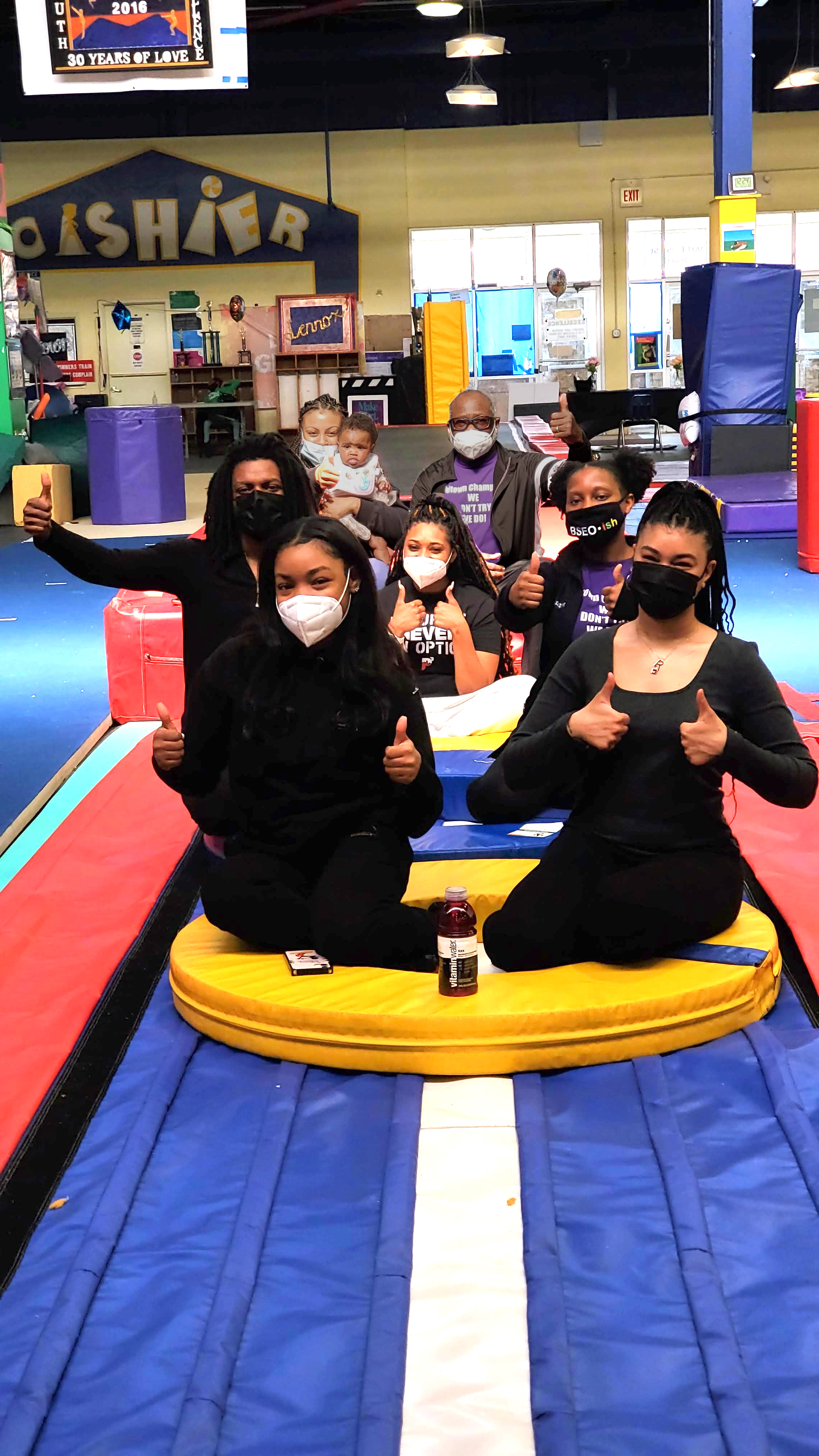 Whitney leaning against a railing on a downtown street